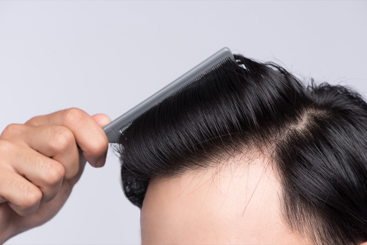 Close up photo of clean healthy man's hair. Young man comb his hair - Image