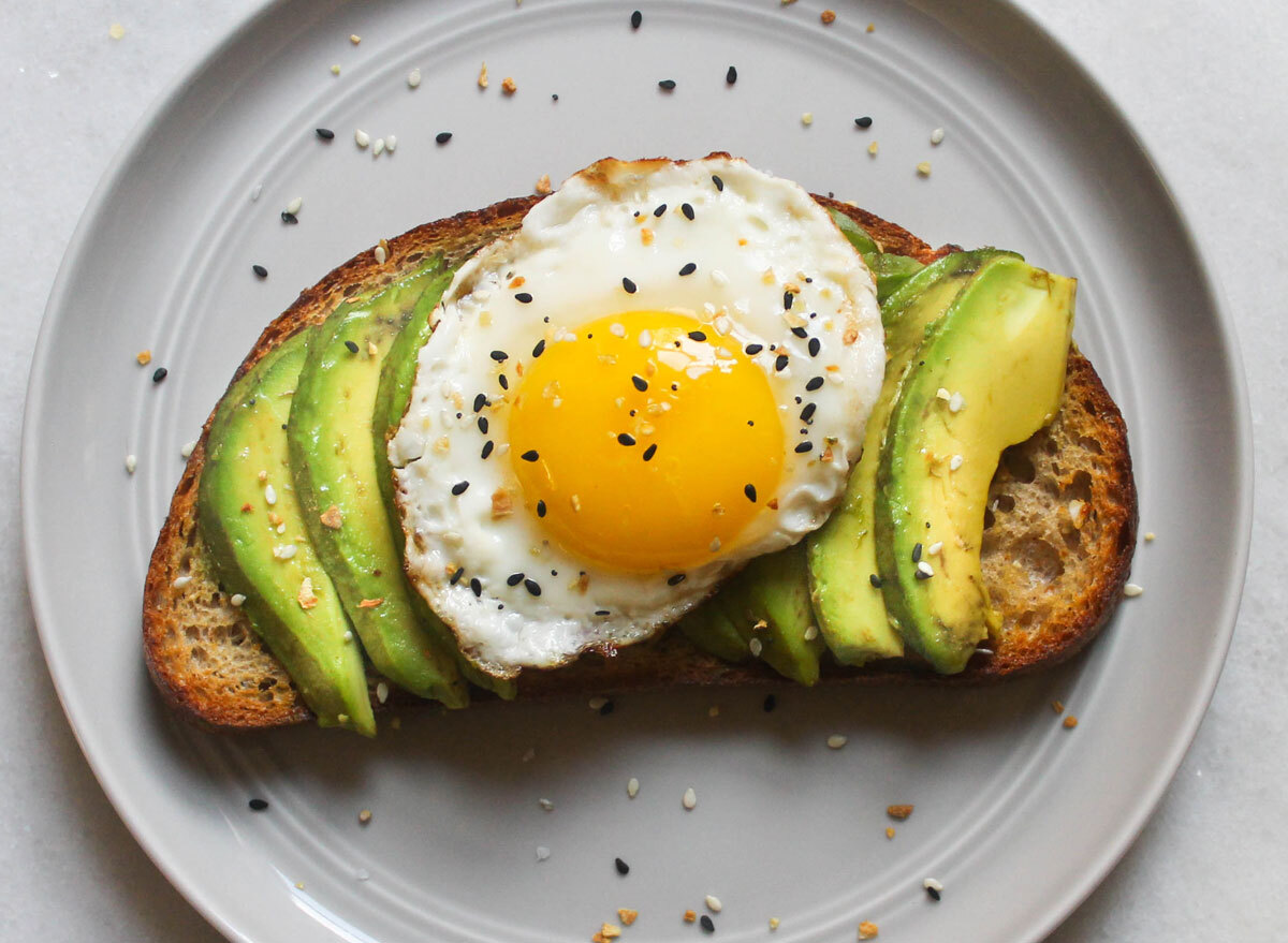 avocado egg everything bagel seasoning toast on grey plate and marble counter