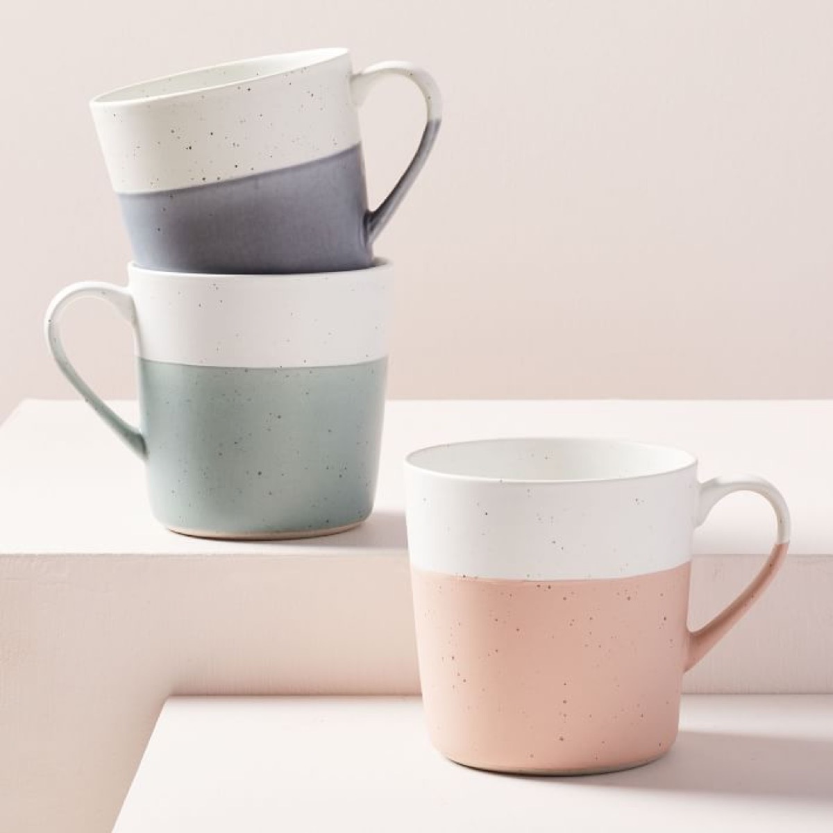 three color blocked speckled mugs in blue green and pink