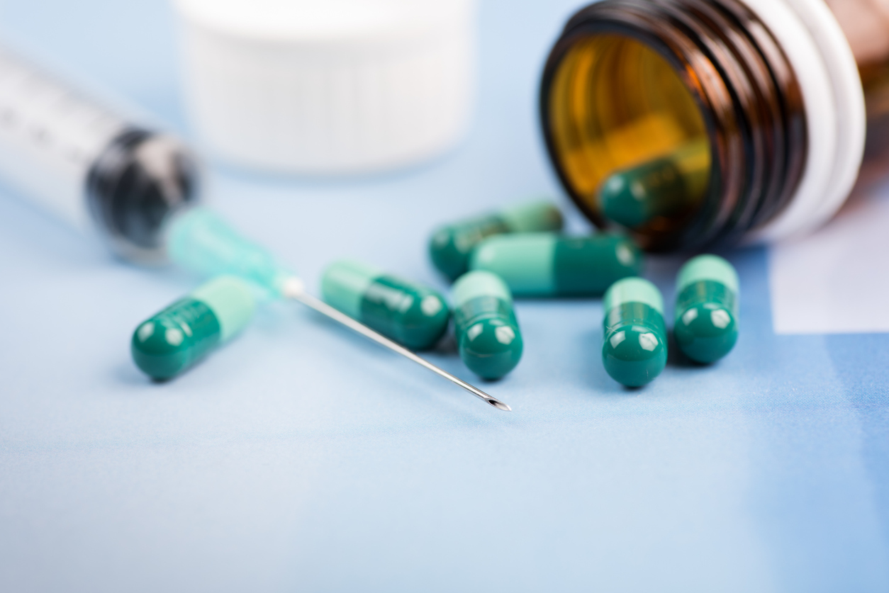 Close-up of pills and a syringe.