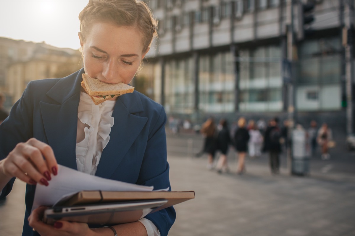 disorganized business person holds papers