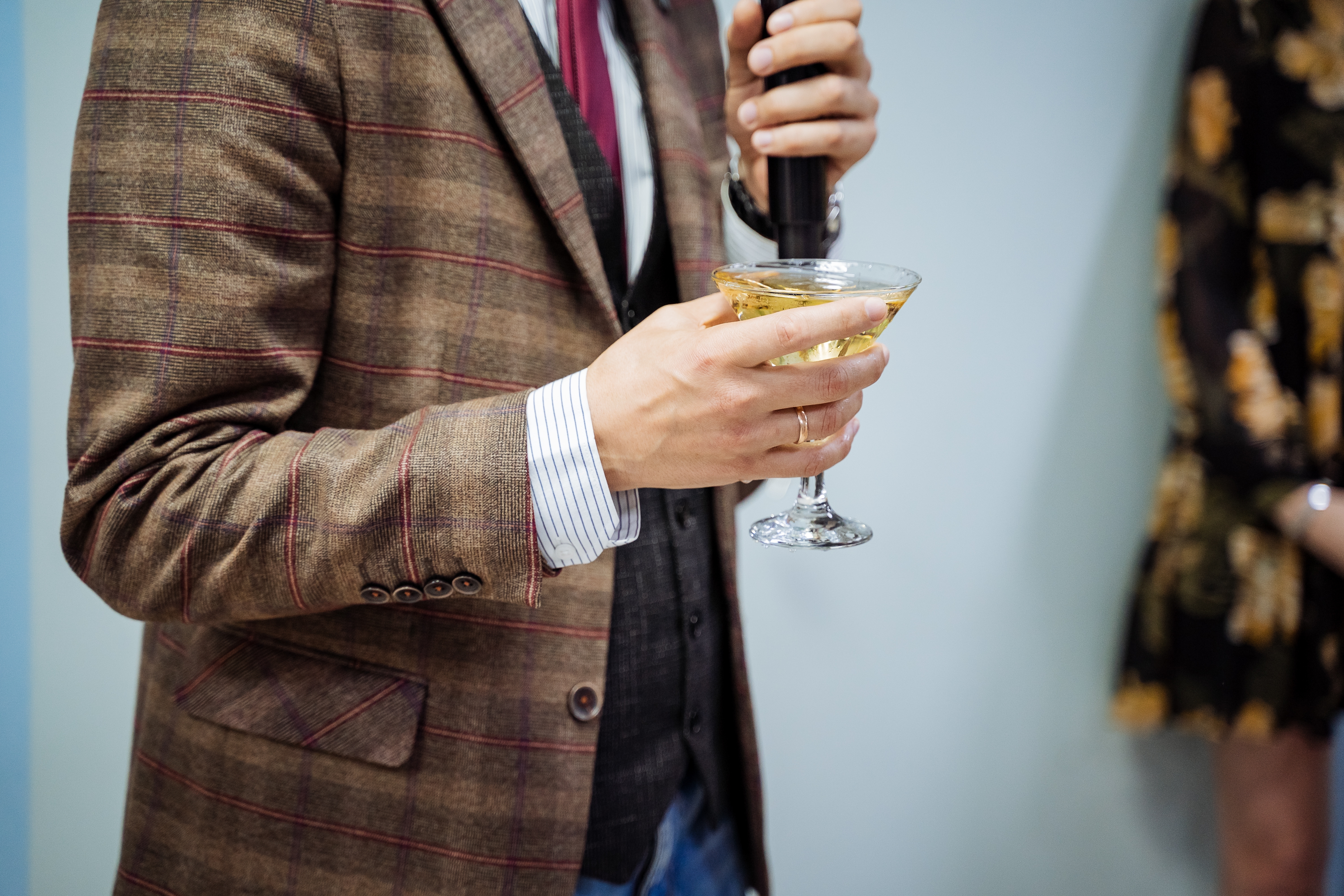 man holding a microphone and a martini giving delivering happy birthday wishes