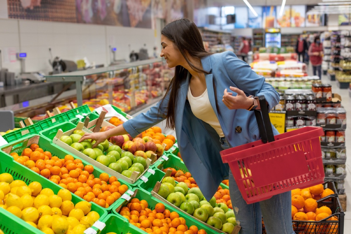 woman buying fresh fruit at the grocery store