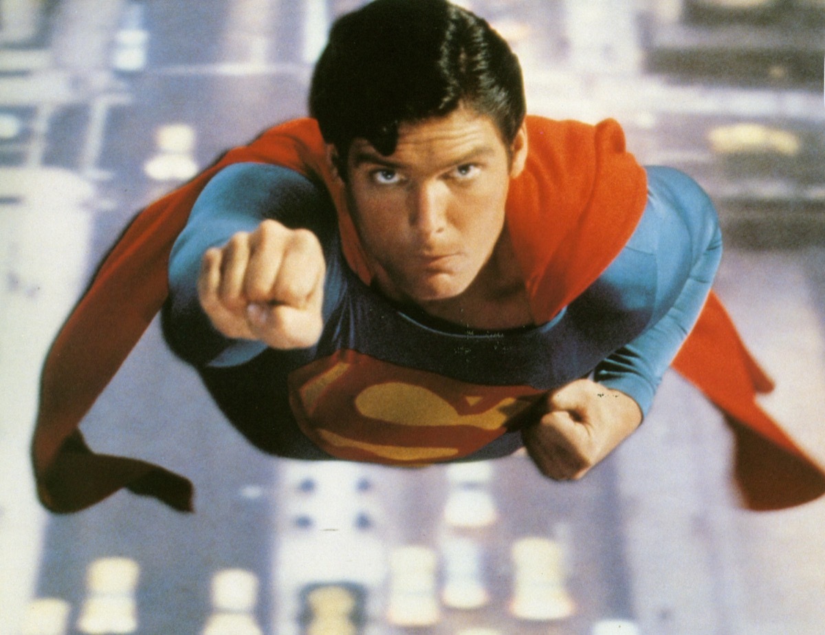 Christopher Reeve flies through the sky with a fist in the air as as Superman in 1978 Warner Bros film 