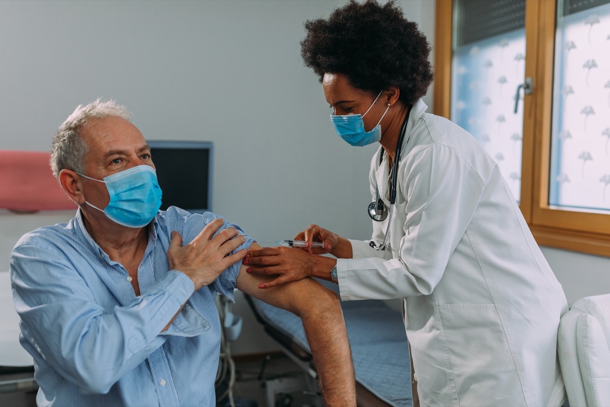 doctor injecting a vaccine into the patient's arm.