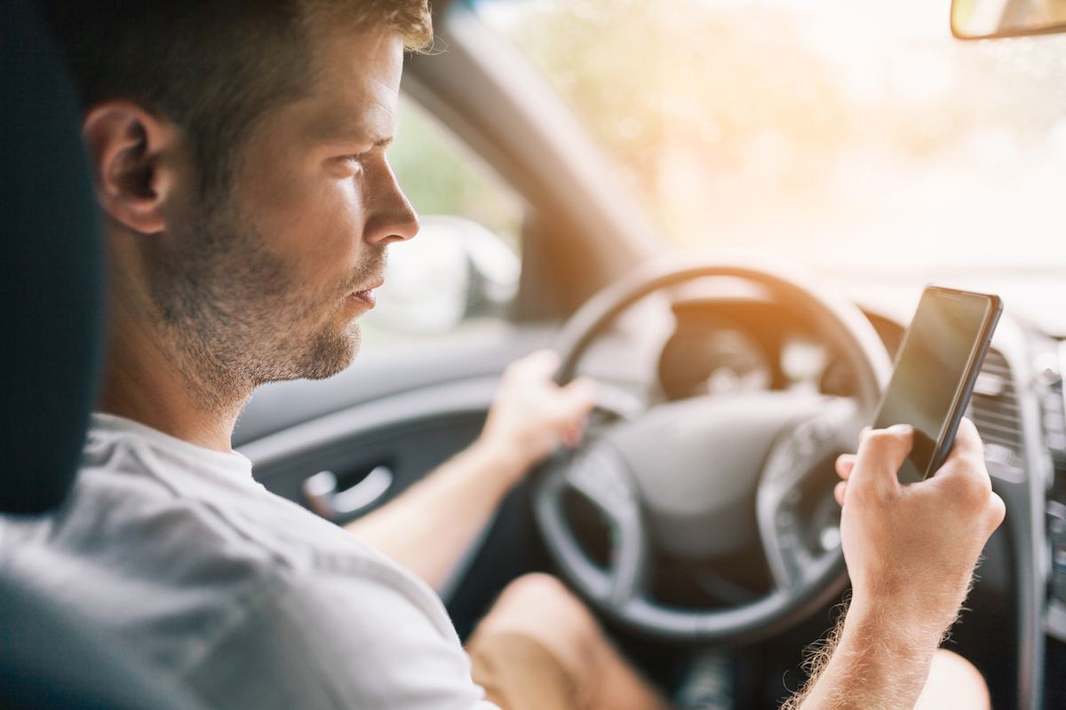 Driver using his mobile phone whilst driving a car