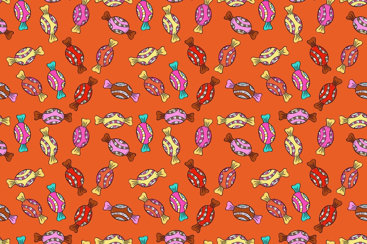 orange wallpaper with little pieces of all different colored candy