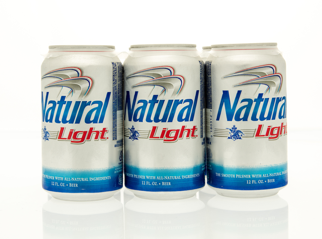 A six pack of Natural Light beer in cans.