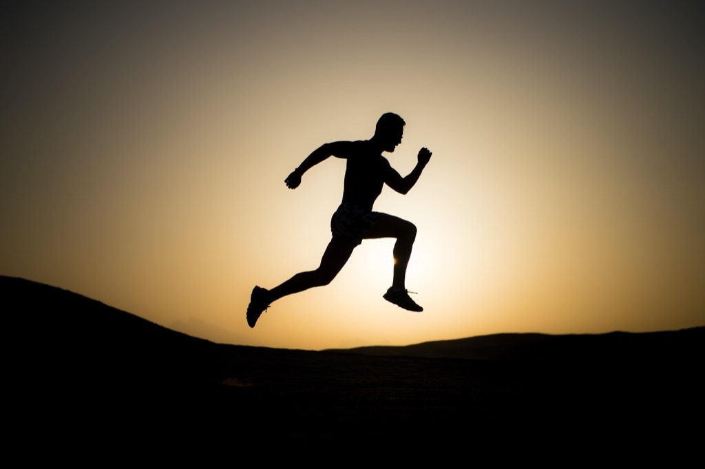 Man running at sunset for low blood pressure