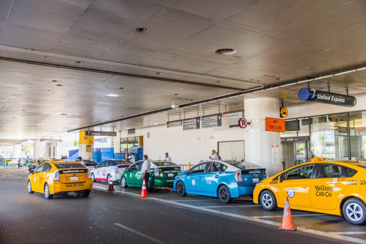 taxi lined up in front of airport