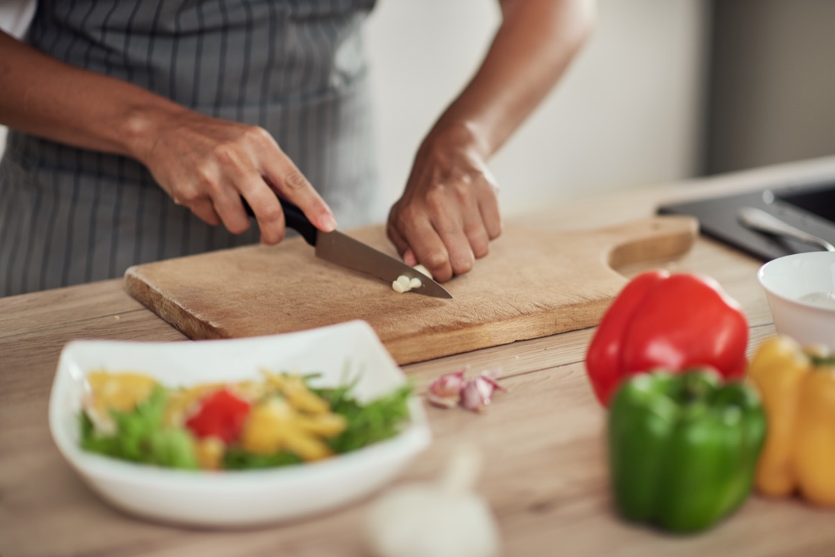 close-up of woman chopping vegetables