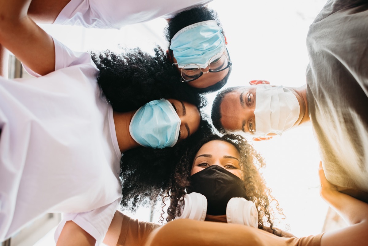 millenial friends taking selfie smiling behind face masks