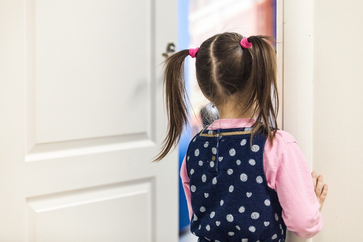 Little girl peeking through a classroom door Classroom Surfaces Germs