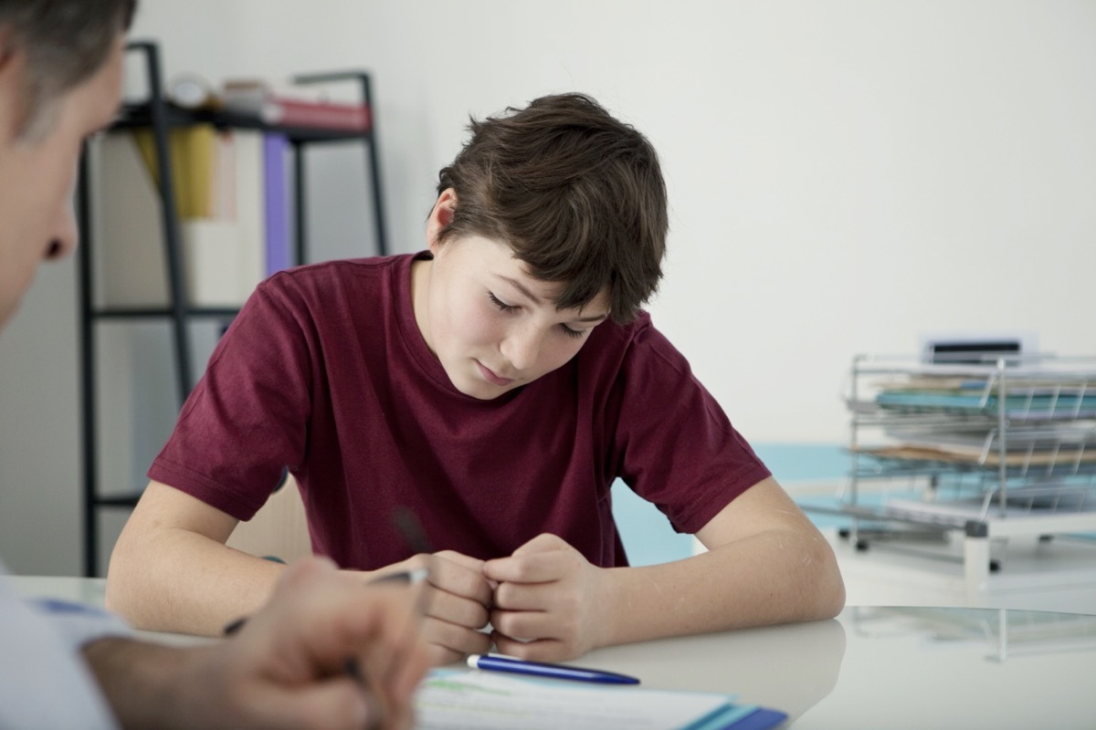 Child psychologist working with upset teenager