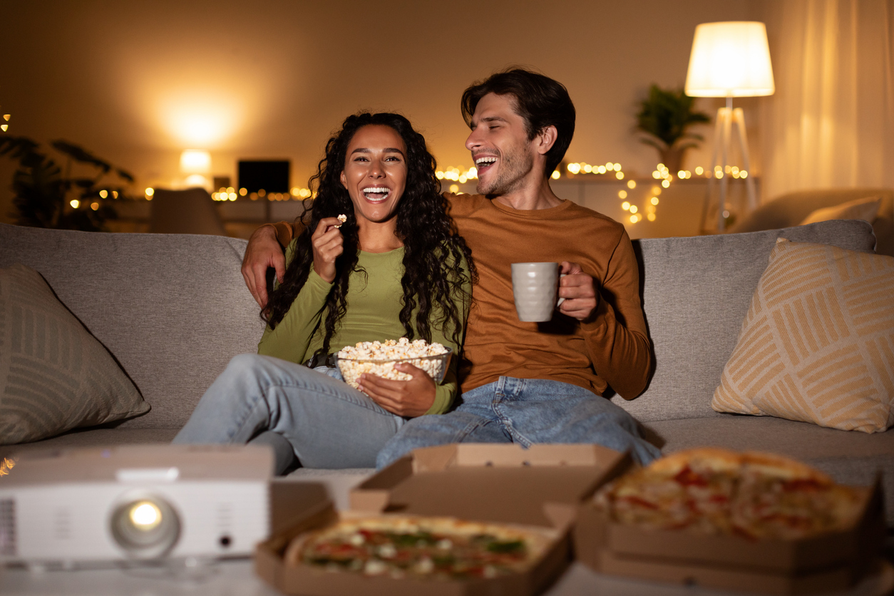 young couple watching movies together