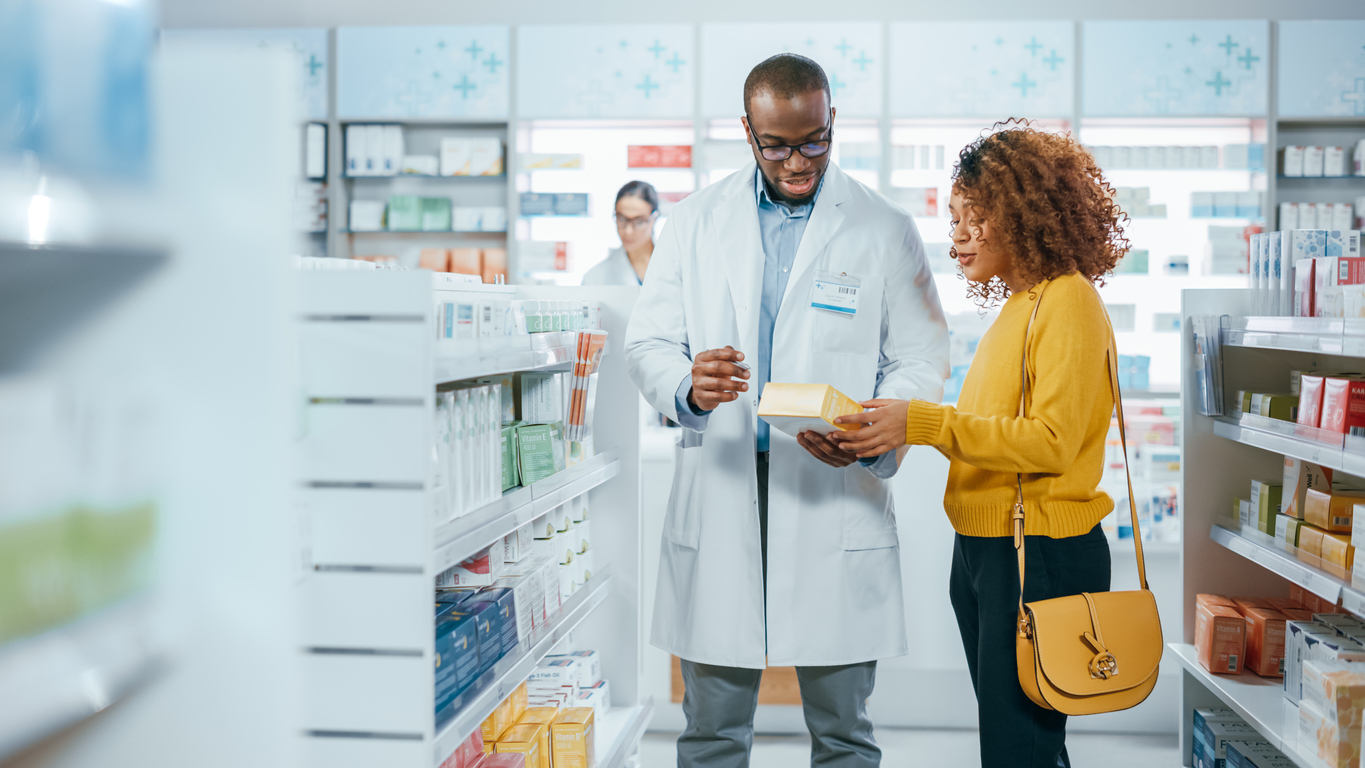 Pharmacist talking to woman. 