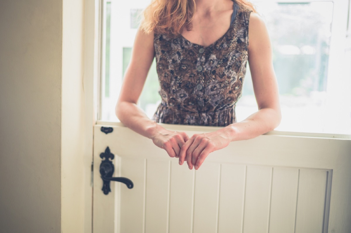 woman standing over stable door, vintage home upgrades