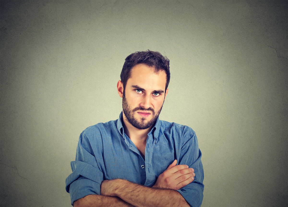 Rude young man with arms crossed