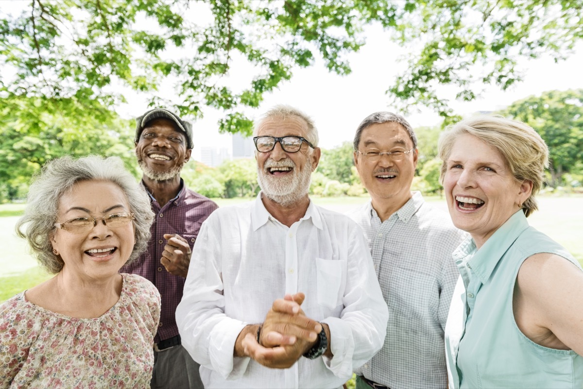 Group of mature friends smiling outside