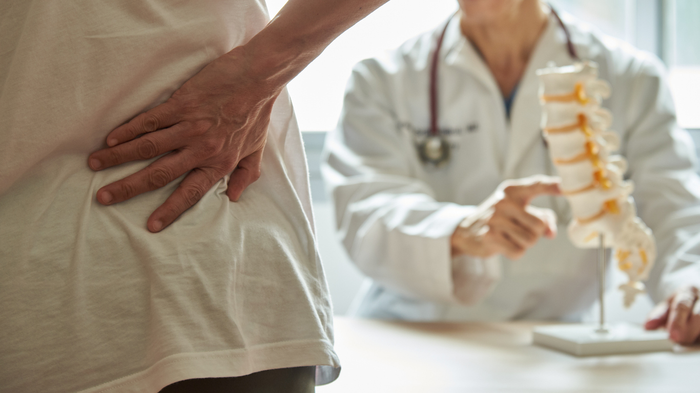 A doctor explaining lumbar anatomy to patient.