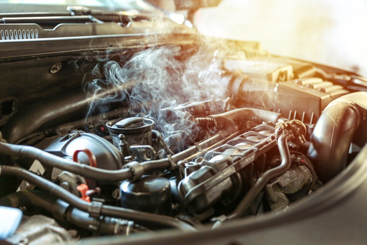 car engine overheating close up. vehicle engine in smoke. smoke or steam from a vehicle engine