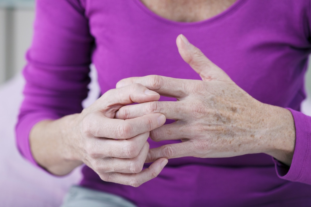 woman rubbing her middle finger