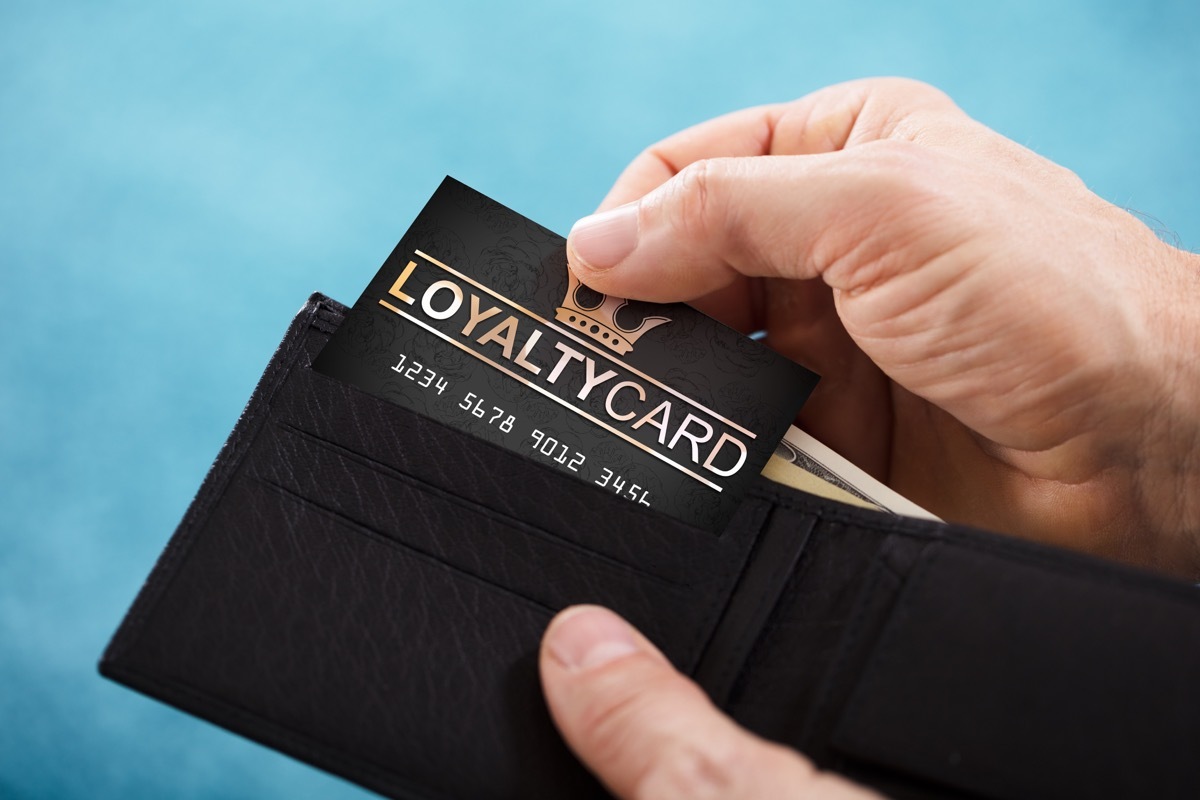 Man pulling loyalty card out of wallet