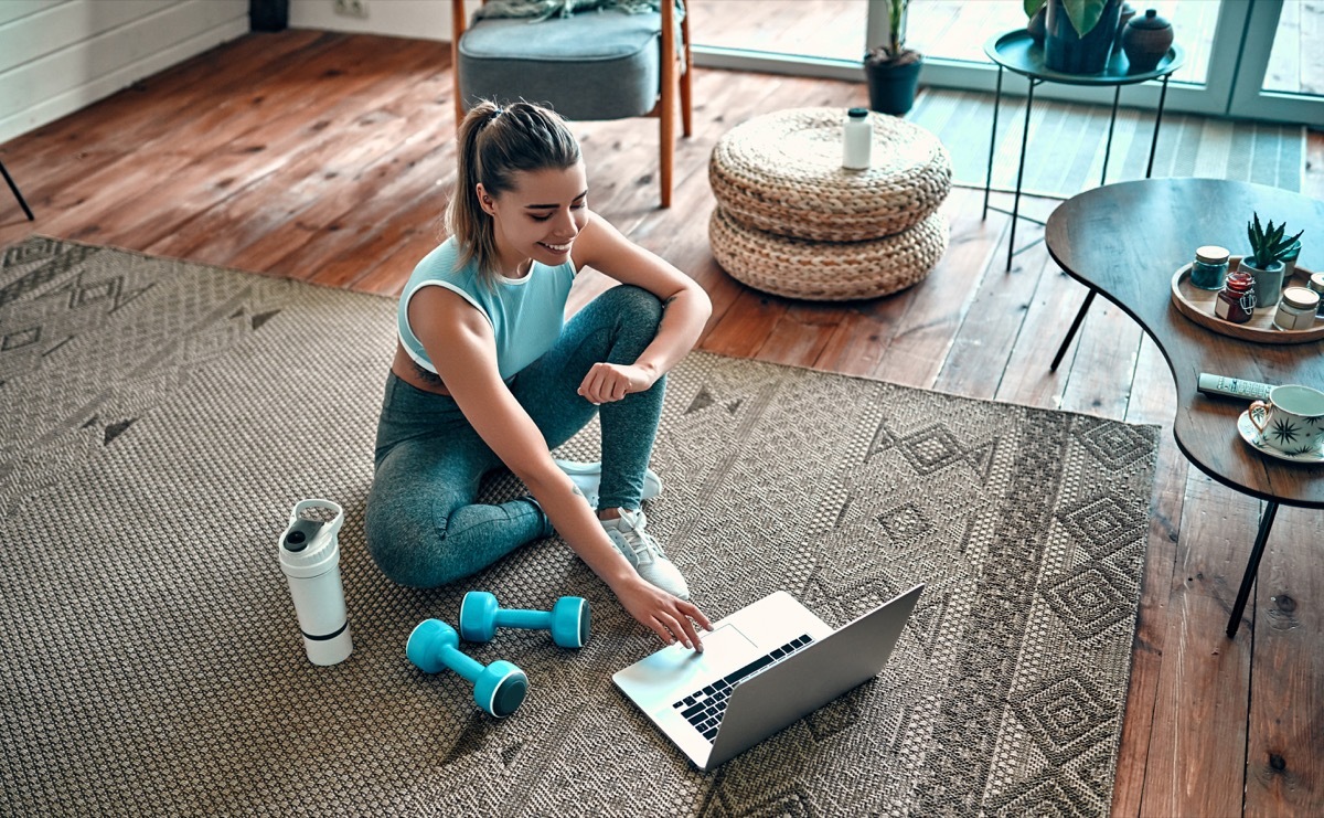 Girl doing at home exercise with weights