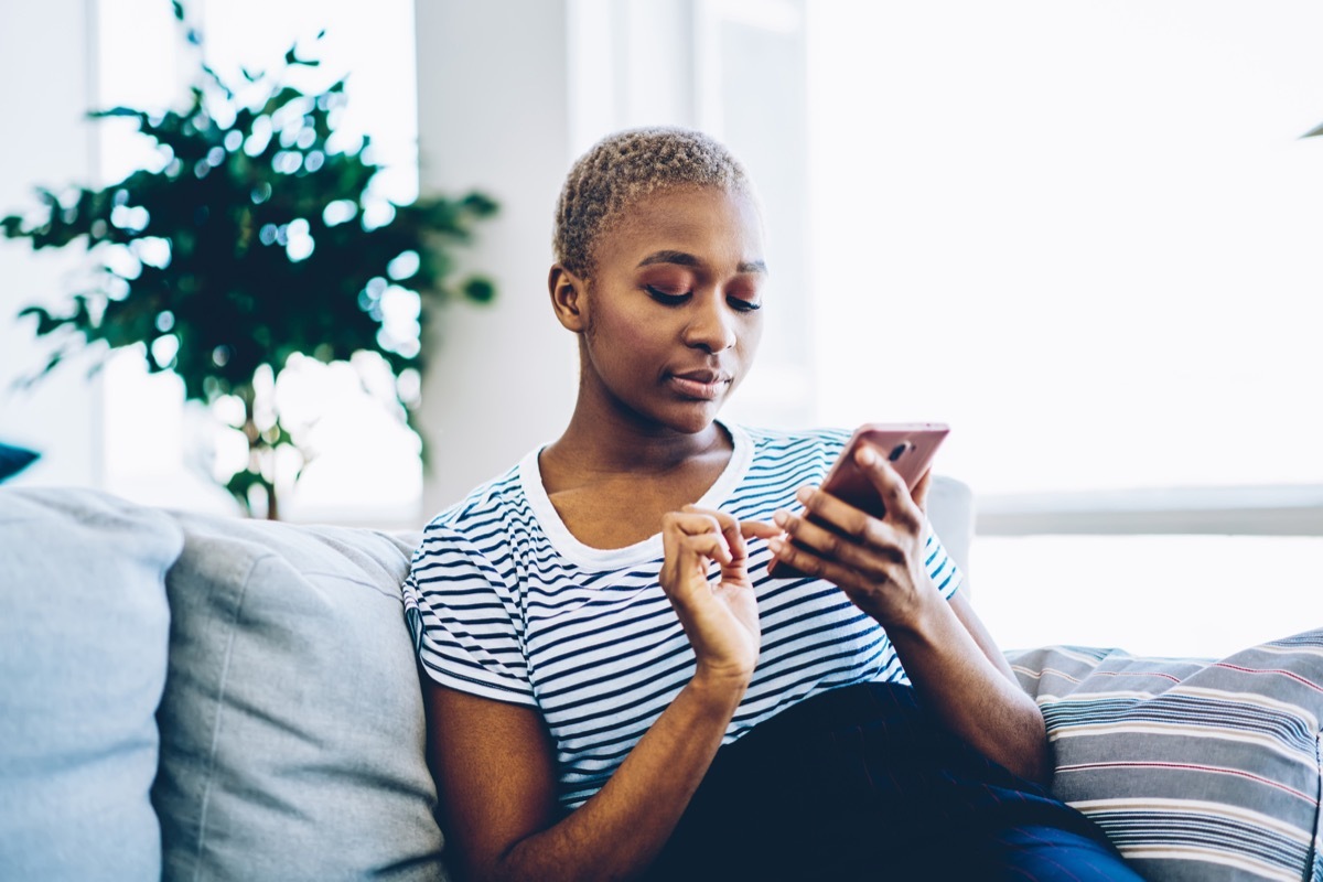 girl on her couch on phone