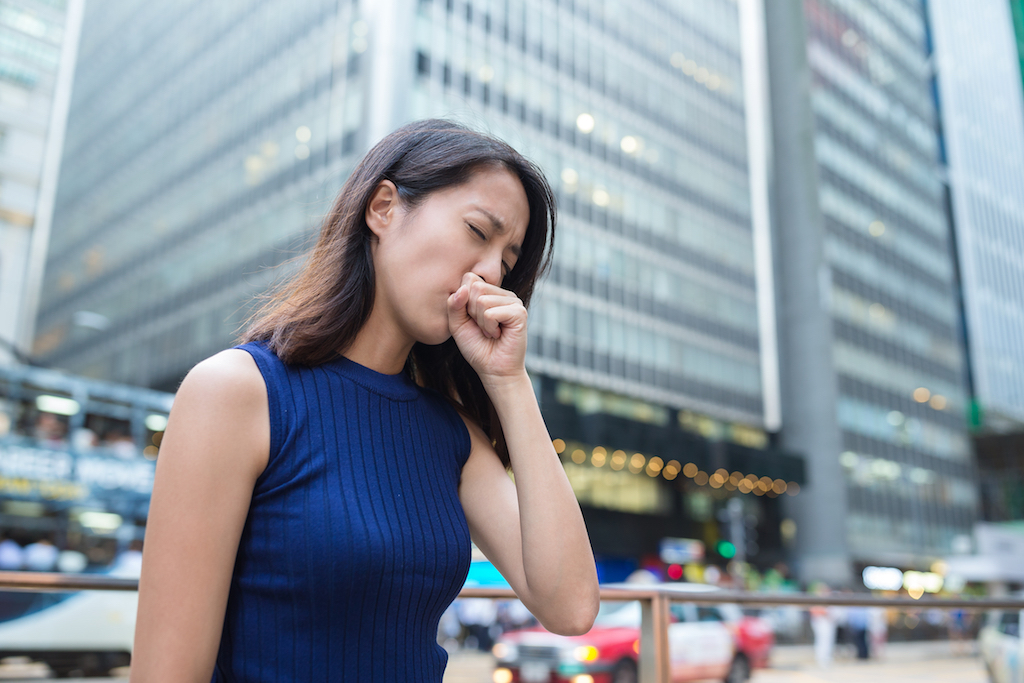 woman coughing on the street