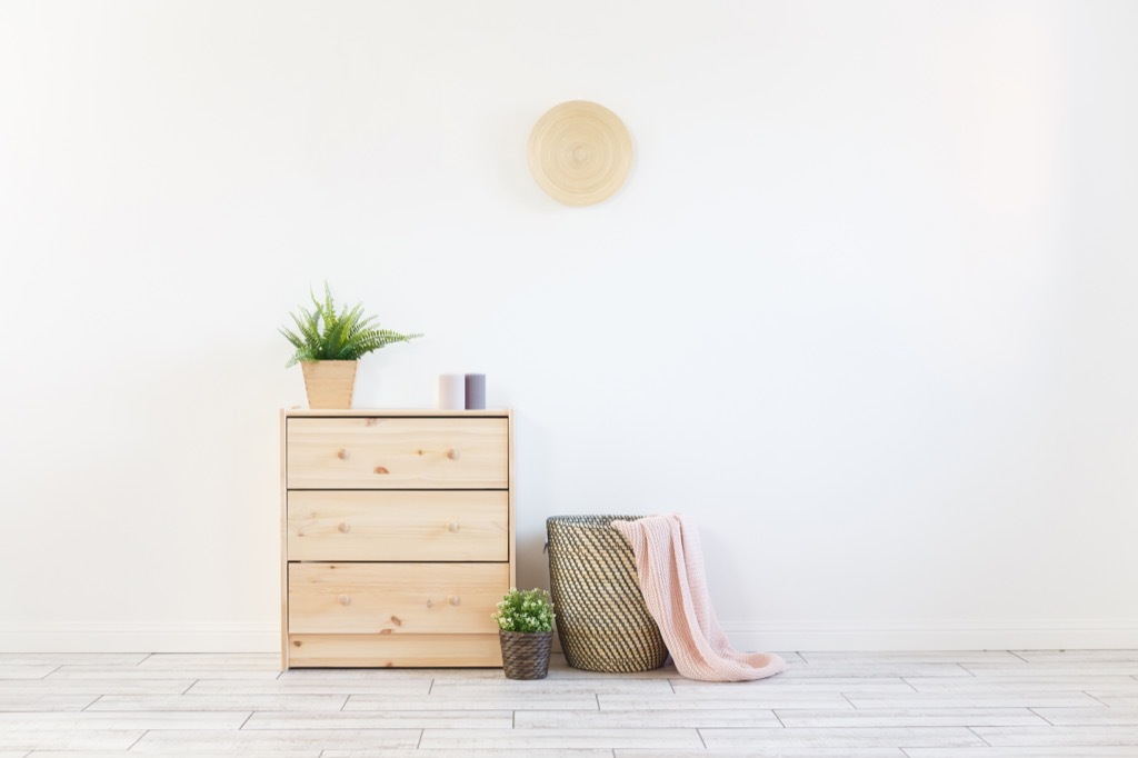 living room with a basket with blankets in it