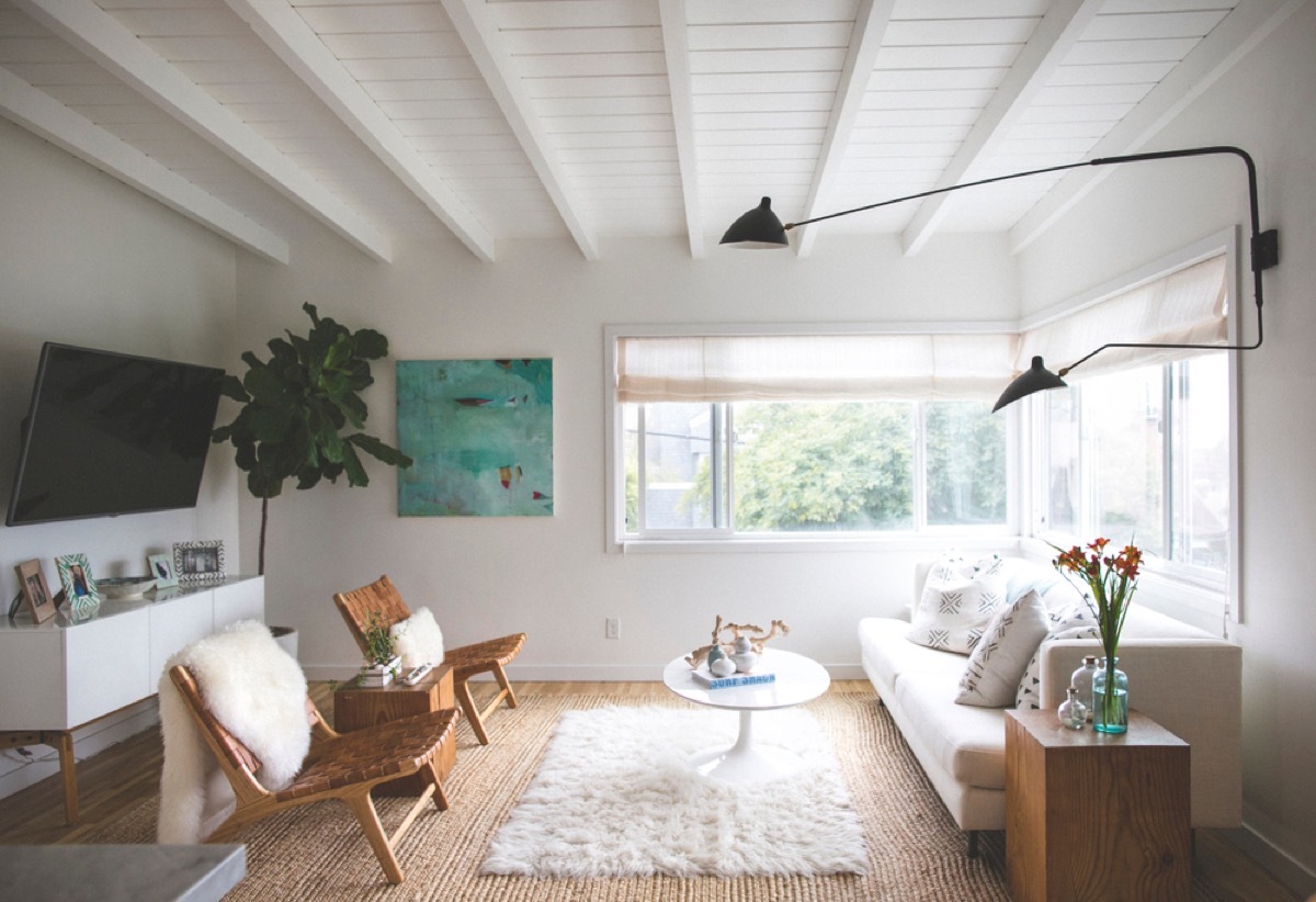 modern home with shag rug, leather chairs, and white shag pillow