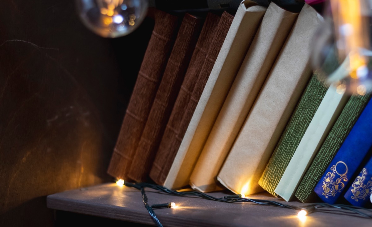 fairy christmas lights on top of a bookshelf