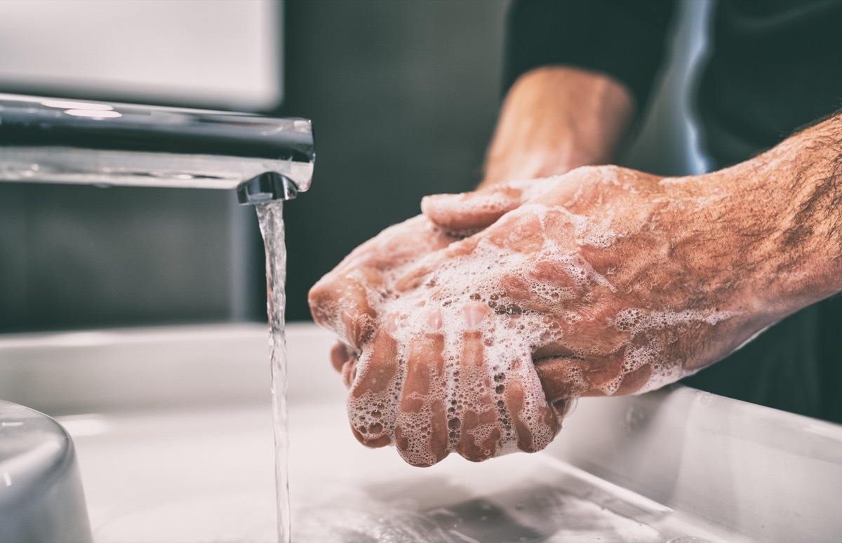 Person washing hands with soap