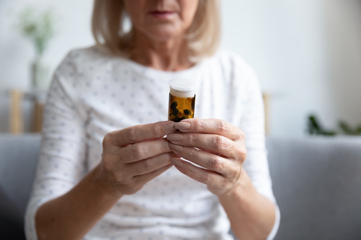 an older woman looking at medicine