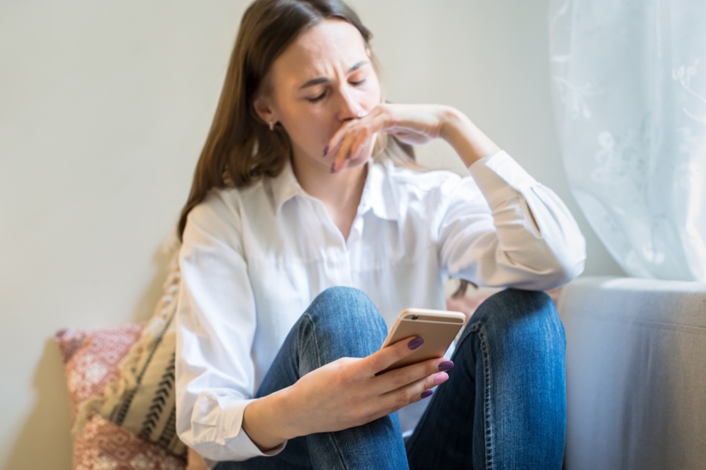 Sad Woman Looking at Phone 25 Years