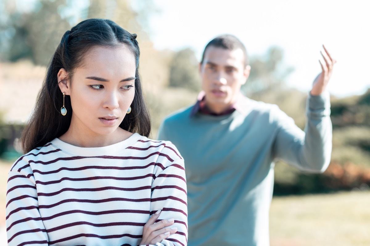 Problems in couple. Negative delighted female person turning head while having bad mood