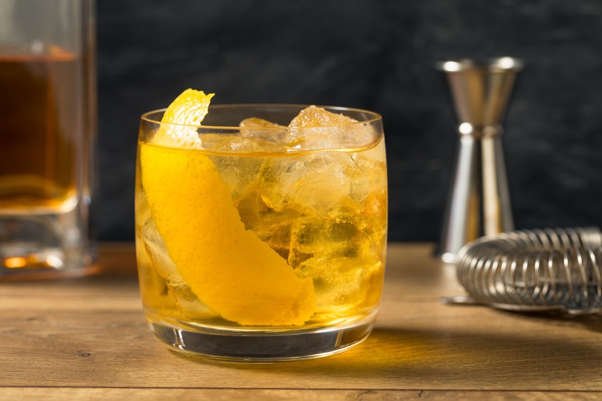 rusty nail cocktail with lemon garnish