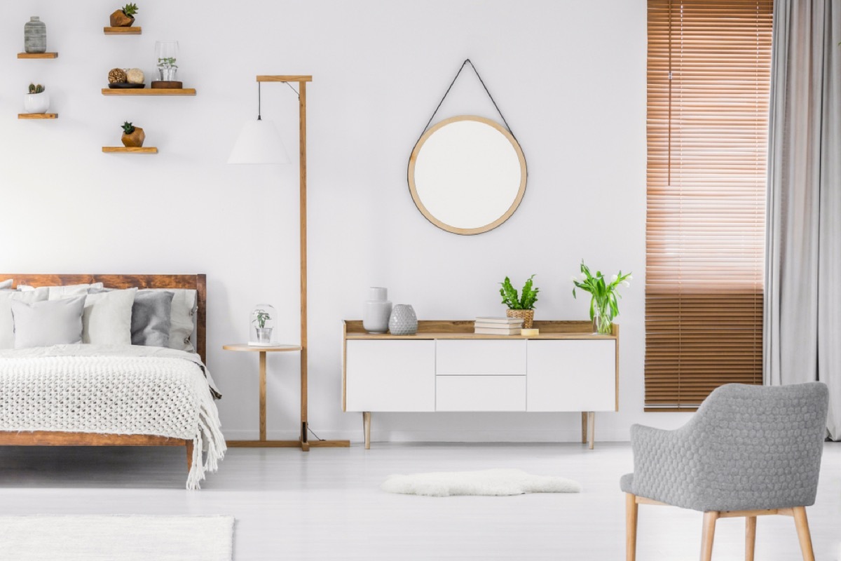 round mirror on wall in scandinavian minimalist room