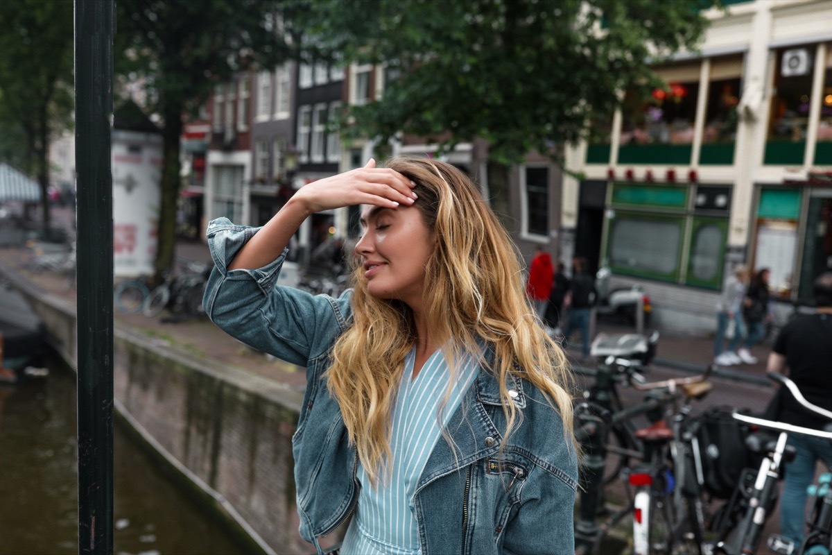 Girl touching her face to move her hair back