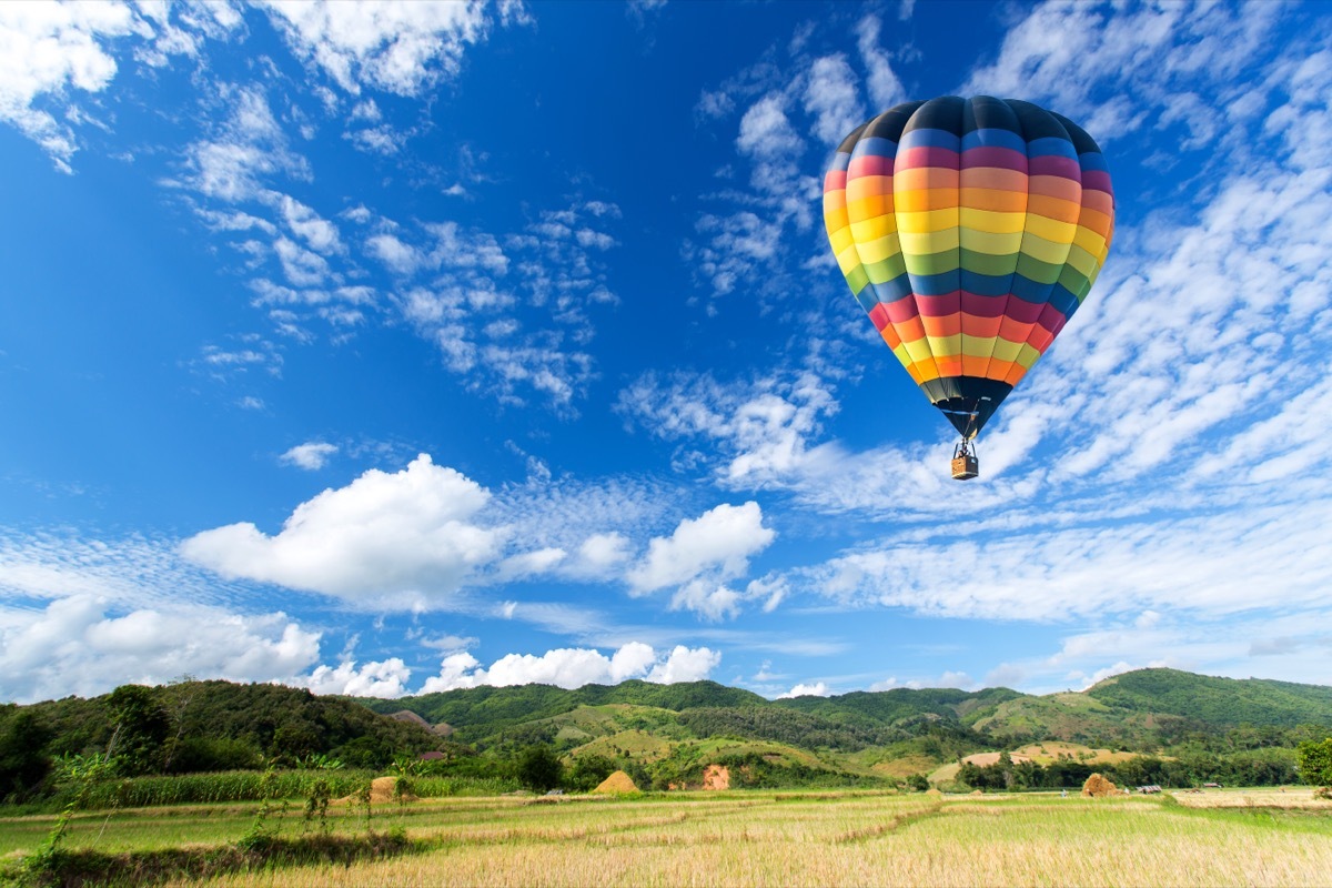 Hot air balloon over the field with blue sky