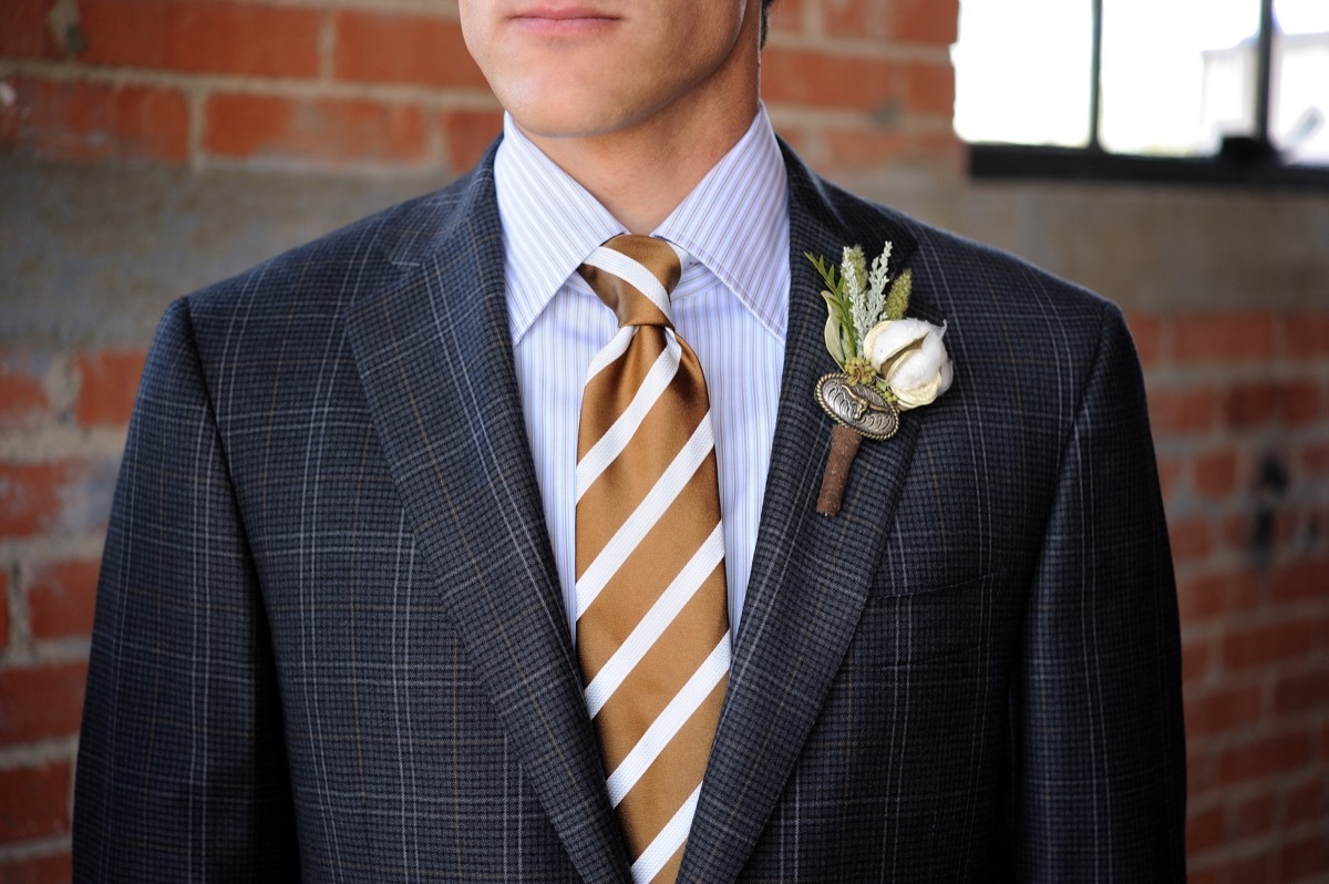 man wearing a striped tie and a plaid jacket