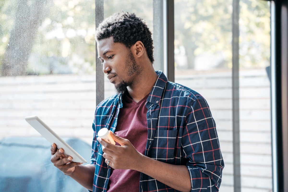 Young man using tablet for pharmaceutical questions