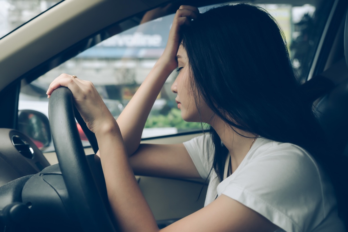 Woman experiencing fatigue while driving