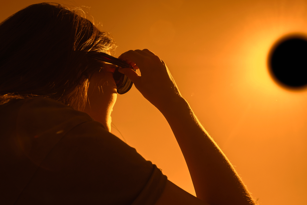 A woman using special glasses to watch a solar eclipse