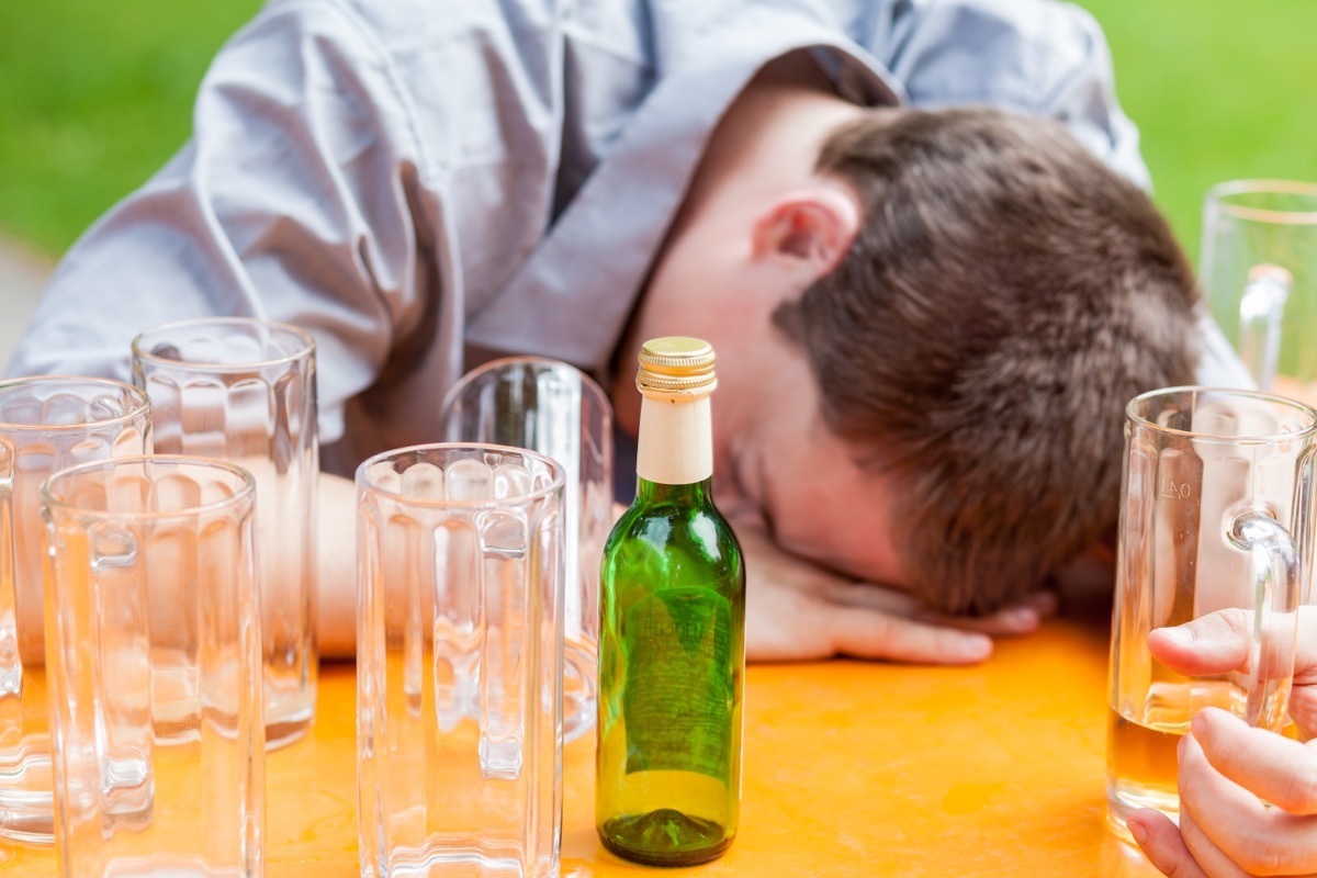 Man Surrounded by Empty Beer Glasses