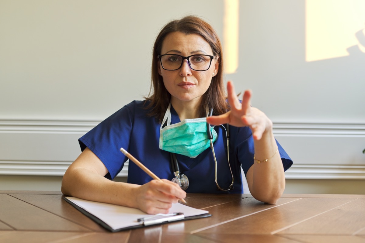 Female doctor looking at webcam