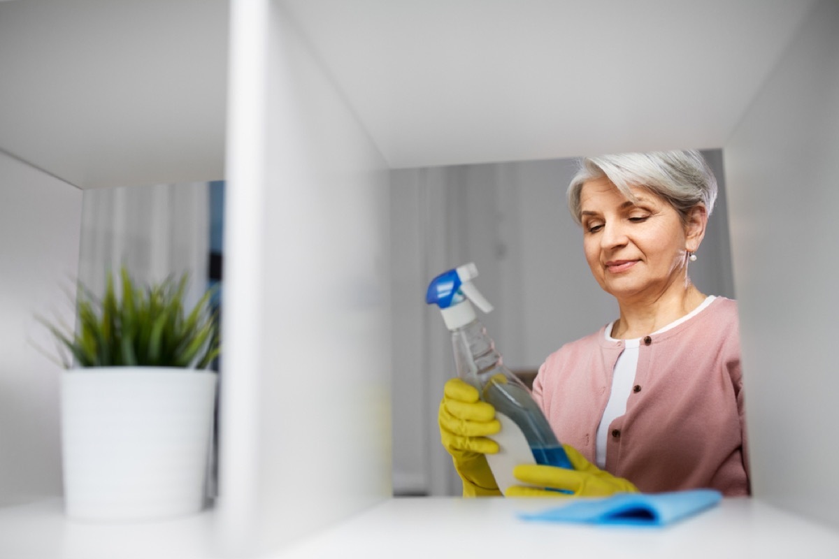 woman looking at bottle of cleaner