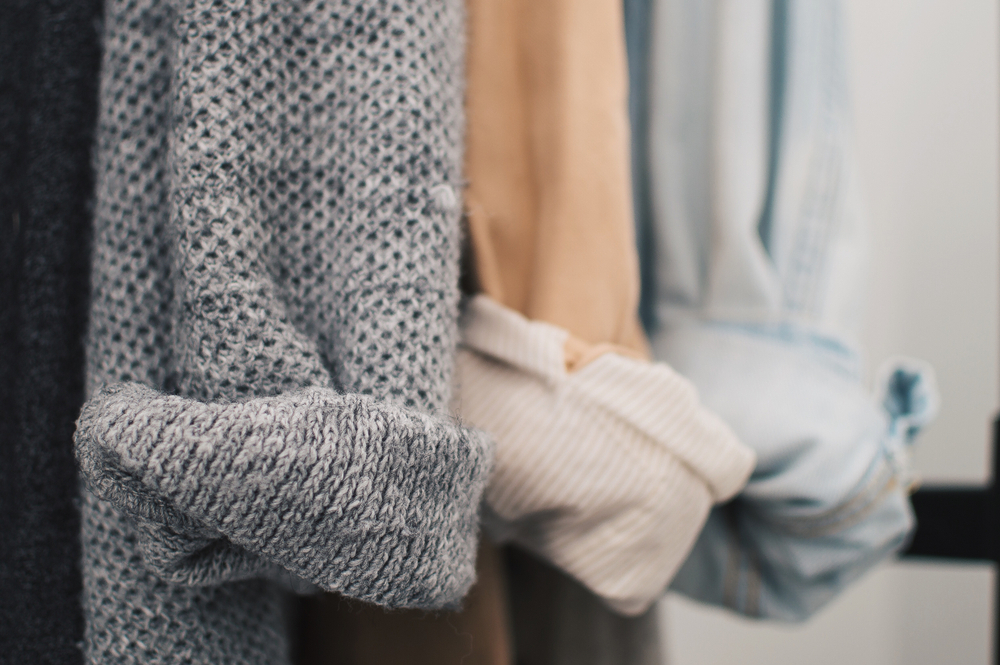 Close up of cardigans and linen button-down shirts