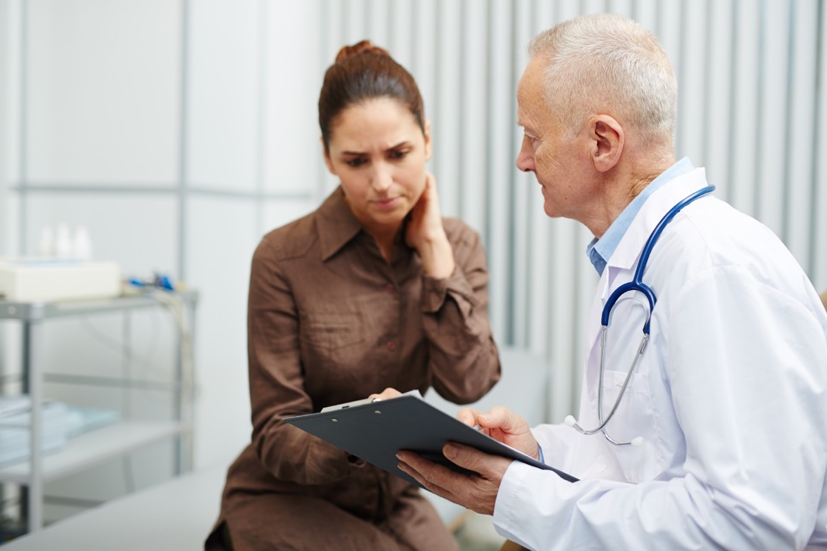 Nervous woman at the doctor touching her neck reading body language